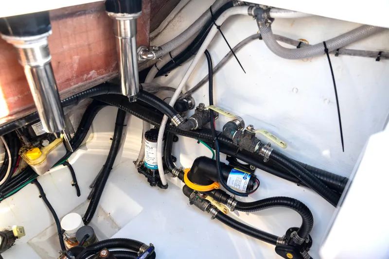  Yacht Photos Pics Engine compartment of a 2024 Freeman 28 boat, showcasing wiring and plumbing details.