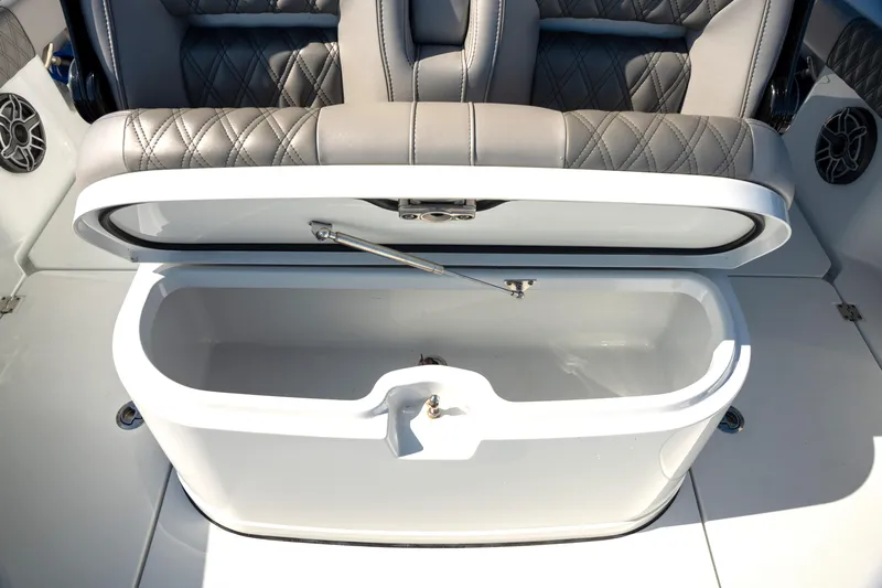  Yacht Photos Pics Open storage compartment on a 2024 Freeman 28 boat with quilted seating.