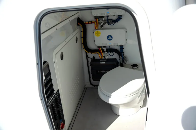  Yacht Photos Pics Interior of 2024 Freeman 28 boat showing compact marine toilet and electrical systems.