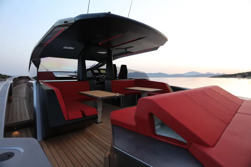 Maori 64 Yacht Photos Pics 2025 Maori M64 yacht interior with red seating, wooden deck, and scenic ocean view.