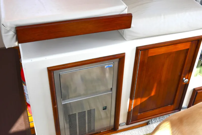 Hardtimes Yacht Photos Pics Interior of 2009 Northern Bay 38 Sportfish with wooden cabinetry and stainless steel appliance.