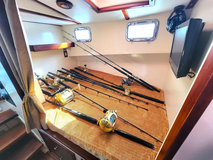 Hardtimes Yacht Photos Pics 2009 Northern Bay 38 Sportfish cabin with fishing rods and reels on a bed.