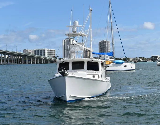 Hardtimes Yacht Photos Pics 2009 Northern Bay 38 Sportfish boat cruising in a coastal city harbor.