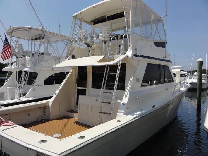  Yacht Photos Pics 1990 Viking 45 Convertible yacht docked at marina, featuring spacious deck and flybridge.