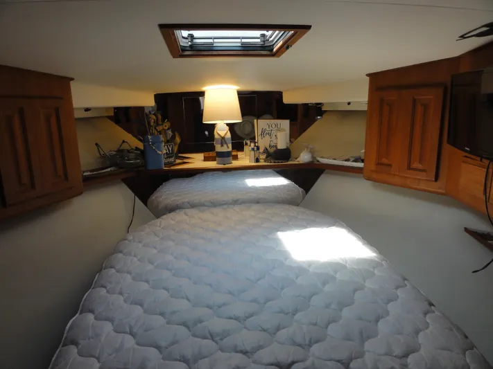  Yacht Photos Pics Cozy cabin interior of 1990 Viking 45 Convertible yacht with twin beds and wooden cabinets.