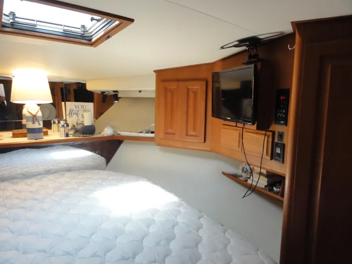  Yacht Photos Pics Cozy interior of 1990 Viking 45 Convertible yacht with bed, TV, and lamp.