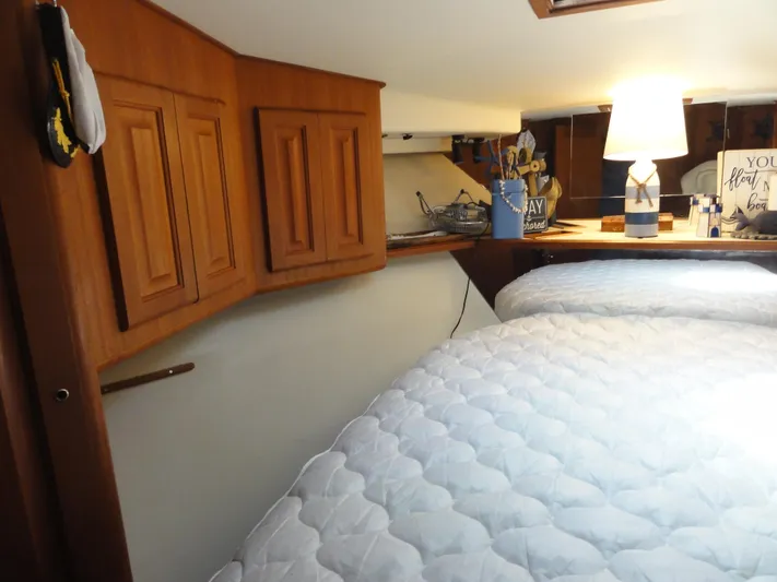  Yacht Photos Pics Cozy cabin interior of 1990 Viking 45 Convertible yacht with wooden cabinets and soft lighting.