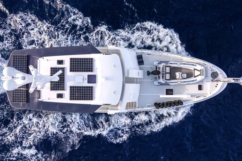 Martini Yacht Photos Pics Aerial view of 2022 Nordhavn N63 yacht cruising on open sea.