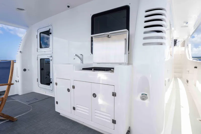 Martini Yacht Photos Pics Outdoor kitchen area on 2022 Nordhavn N63 yacht, featuring grill and sink.