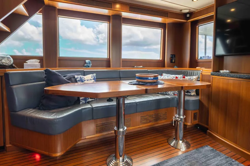 Martini Yacht Photos Pics Luxurious interior of 2022 Nordhavn N63 yacht with elegant wood finishes and plush seating.