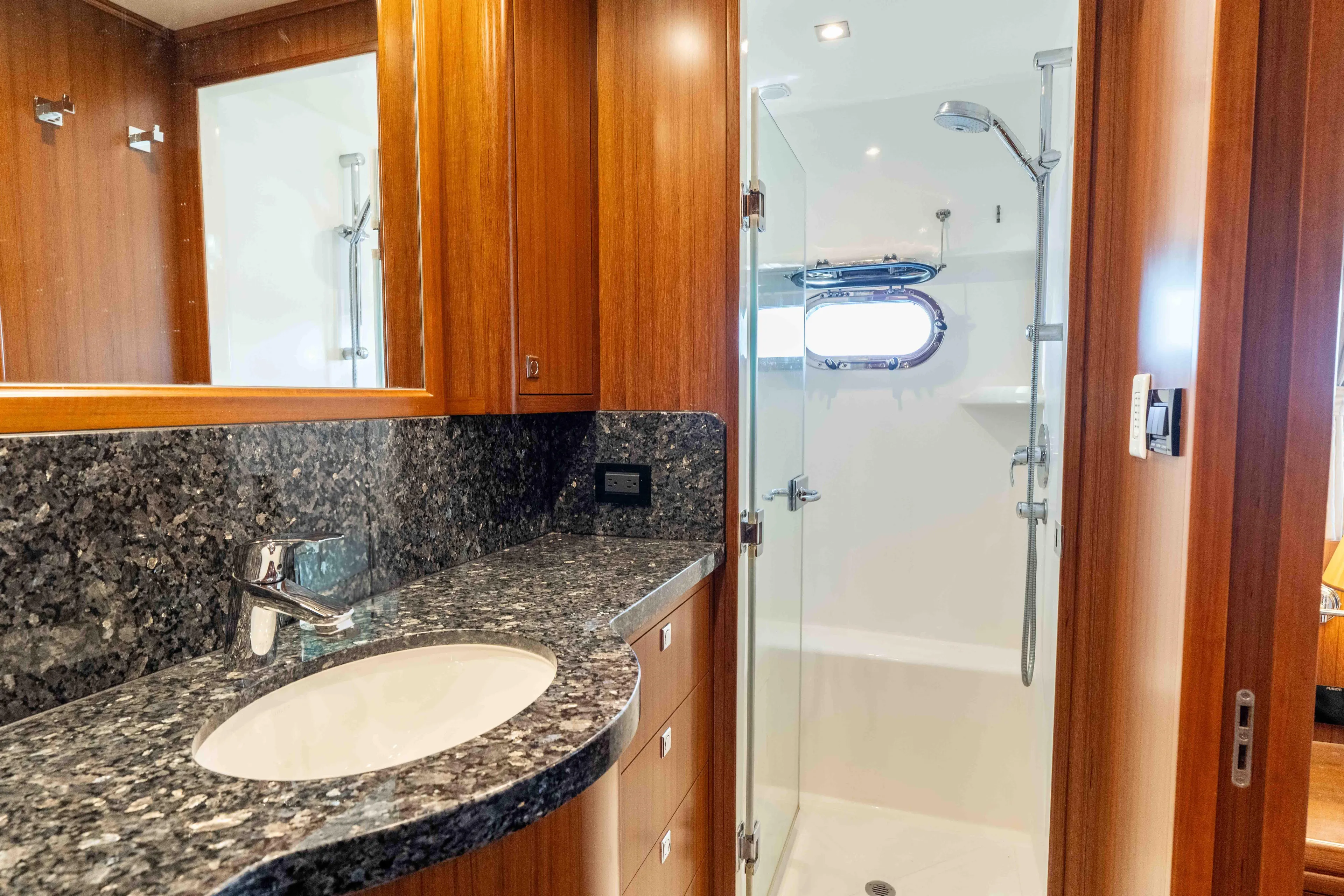 Martini Yacht Photos Pics Luxurious bathroom in 2022 Nordhavn N63 yacht with granite countertop and glass shower.