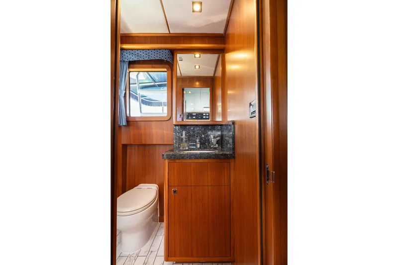 Martini Yacht Photos Pics Luxurious bathroom interior of 2022 Nordhavn N63 yacht with wood finish and modern fixtures.