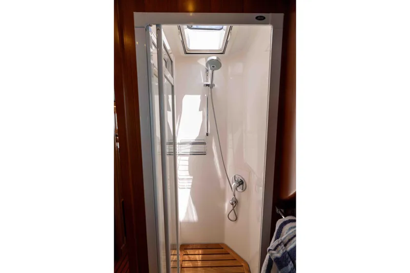 Martini Yacht Photos Pics Shower area in 2022 Nordhavn N63 yacht with wooden floor and modern fixtures.