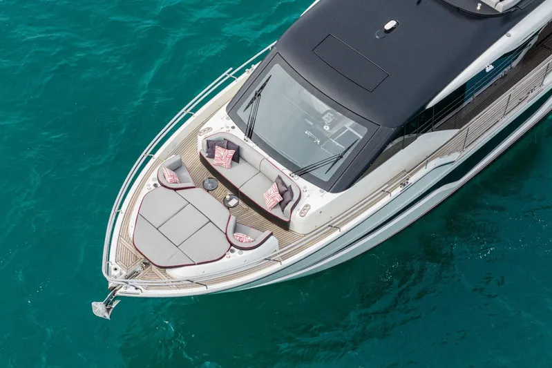  Yacht Photos Pics 2026 Cranchi Sessantasette 67 Corsa yacht with luxurious deck seating on turquoise water.