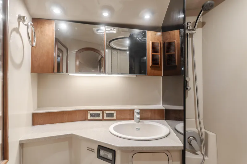 Pez Finder Yacht Photos Pics Luxurious bathroom in 2006 Rampage 38 Express yacht with modern fixtures and wood accents.