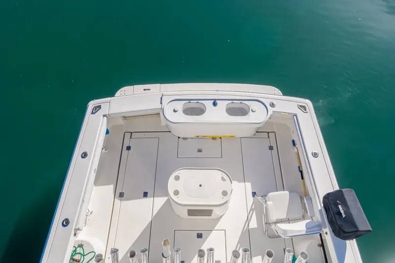 Pez Finder Yacht Photos Pics 2006 Rampage 38 Express boat deck with fishing rod holders and seating.