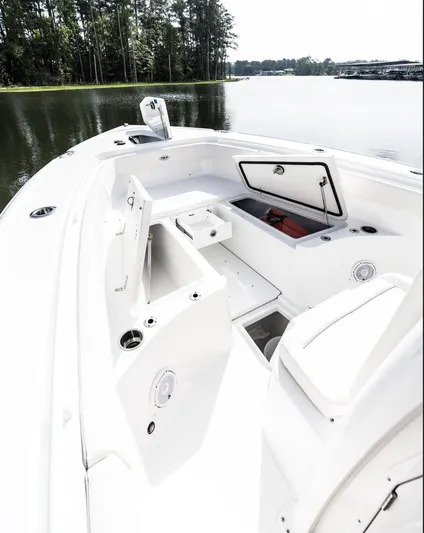  Yacht Photos Pics 2025 Sea Hunt Ultra 275 SE boat interior with open storage compartments on a calm lake.