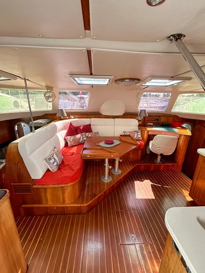 Whatabout Yacht Photos Pics Luxurious interior of 2005 Antares PDQ 44 yacht with elegant wood finish and plush seating.