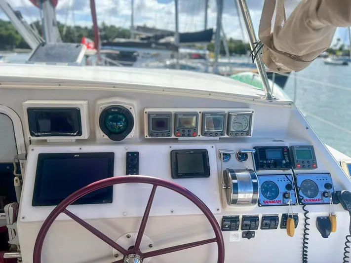 Whatabout Yacht Photos Pics Cockpit of 2005 Antares PDQ 44 yacht with navigation instruments and steering wheel.