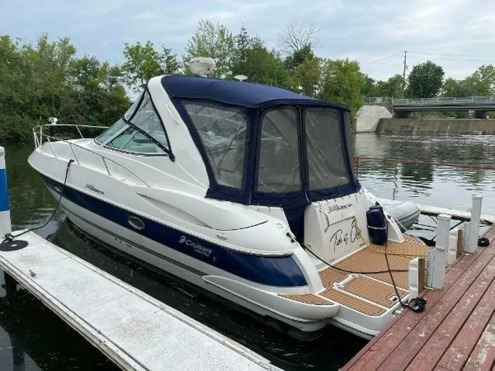  Yacht Photos Pics 2006 Cruisers Yachts 340 Express docked by a serene riverside.