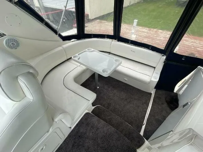  Yacht Photos Pics 2006 Cruisers Yachts 340 Express interior with white seating and a small table.