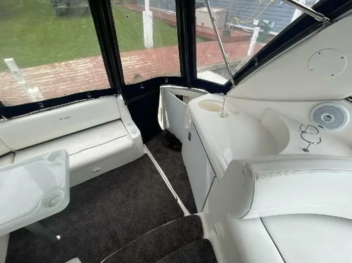  Yacht Photos Pics 2006 Cruisers Yachts 340 Express interior with white seating and carpeted flooring.