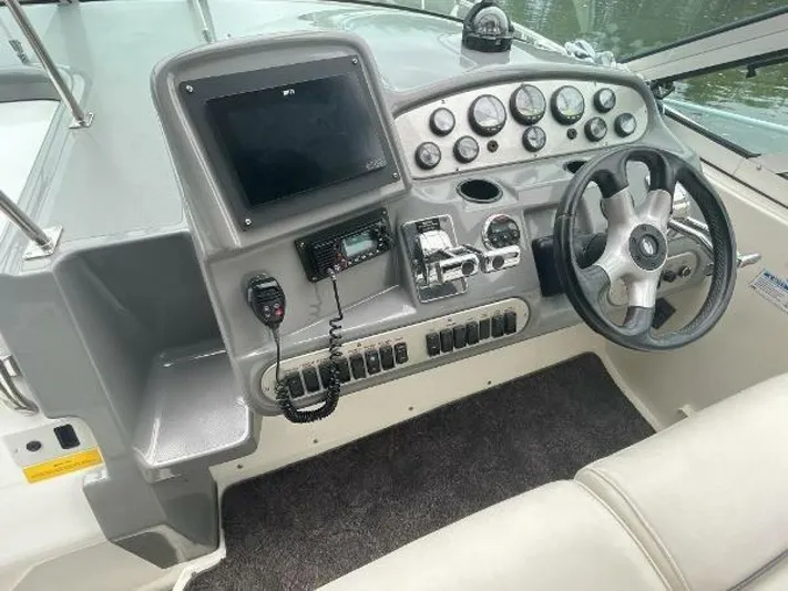  Yacht Photos Pics 2006 Cruisers Yachts 340 Express helm with steering wheel and control panel.