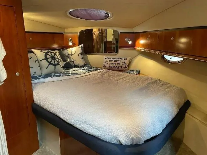  Yacht Photos Pics Interior of 2006 Cruisers Yachts 340 Express with cozy bed and nautical decor.