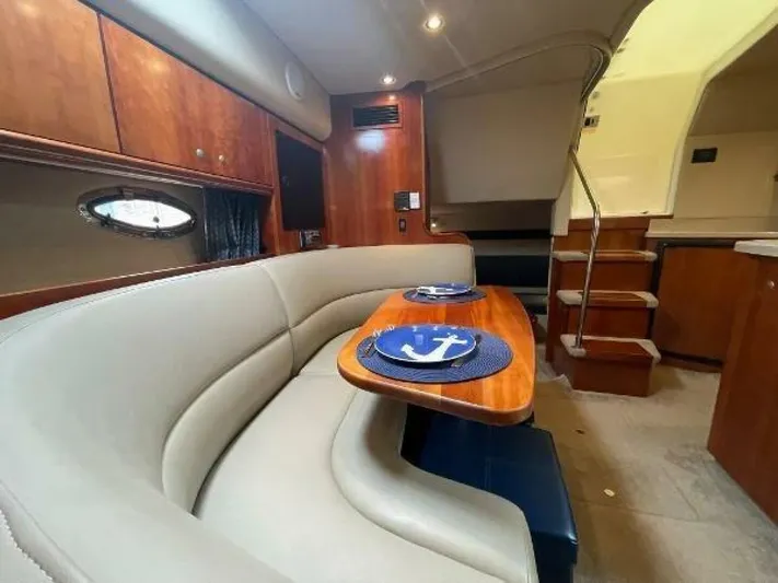  Yacht Photos Pics 2006 Cruisers Yachts 340 Express interior with elegant dining area and wooden cabinetry.