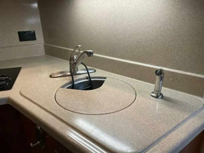  Yacht Photos Pics 2006 Cruisers Yachts 340 Express kitchen sink with faucet and countertop.