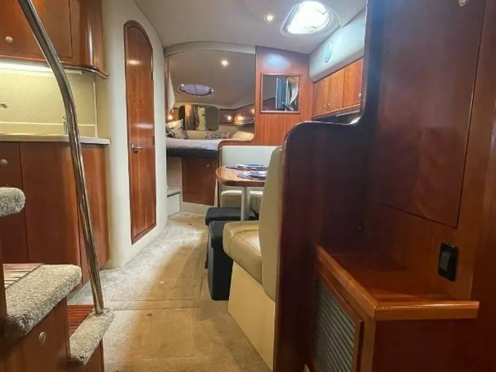  Yacht Photos Pics 2006 Cruisers Yachts 340 Express interior with wood finish and cozy seating area.