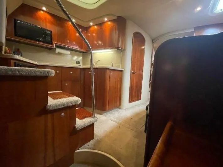  Yacht Photos Pics Interior of 2006 Cruisers Yachts 340 Express, featuring a modern kitchen and wooden cabinetry.