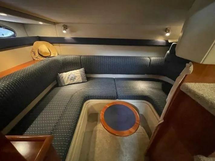  Yacht Photos Pics 2006 Cruisers Yachts 340 Express interior with cozy seating and elegant wood accents.