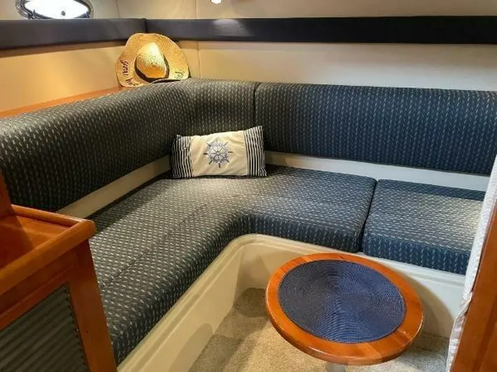  Yacht Photos Pics 2006 Cruisers Yachts 340 Express interior with blue seating and nautical decor.