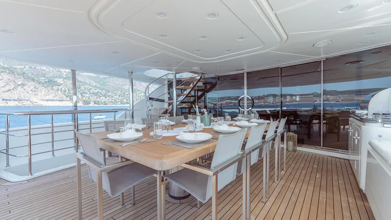 Away Yacht Photos Pics Luxurious 2009 Sanlorenzo SD125 yacht deck with elegant dining area and scenic ocean view.