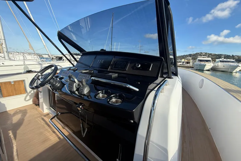King Mouss Yacht Photos Pics Cockpit view of 2020 Pardo Yachts 43, showcasing steering and controls at marina.