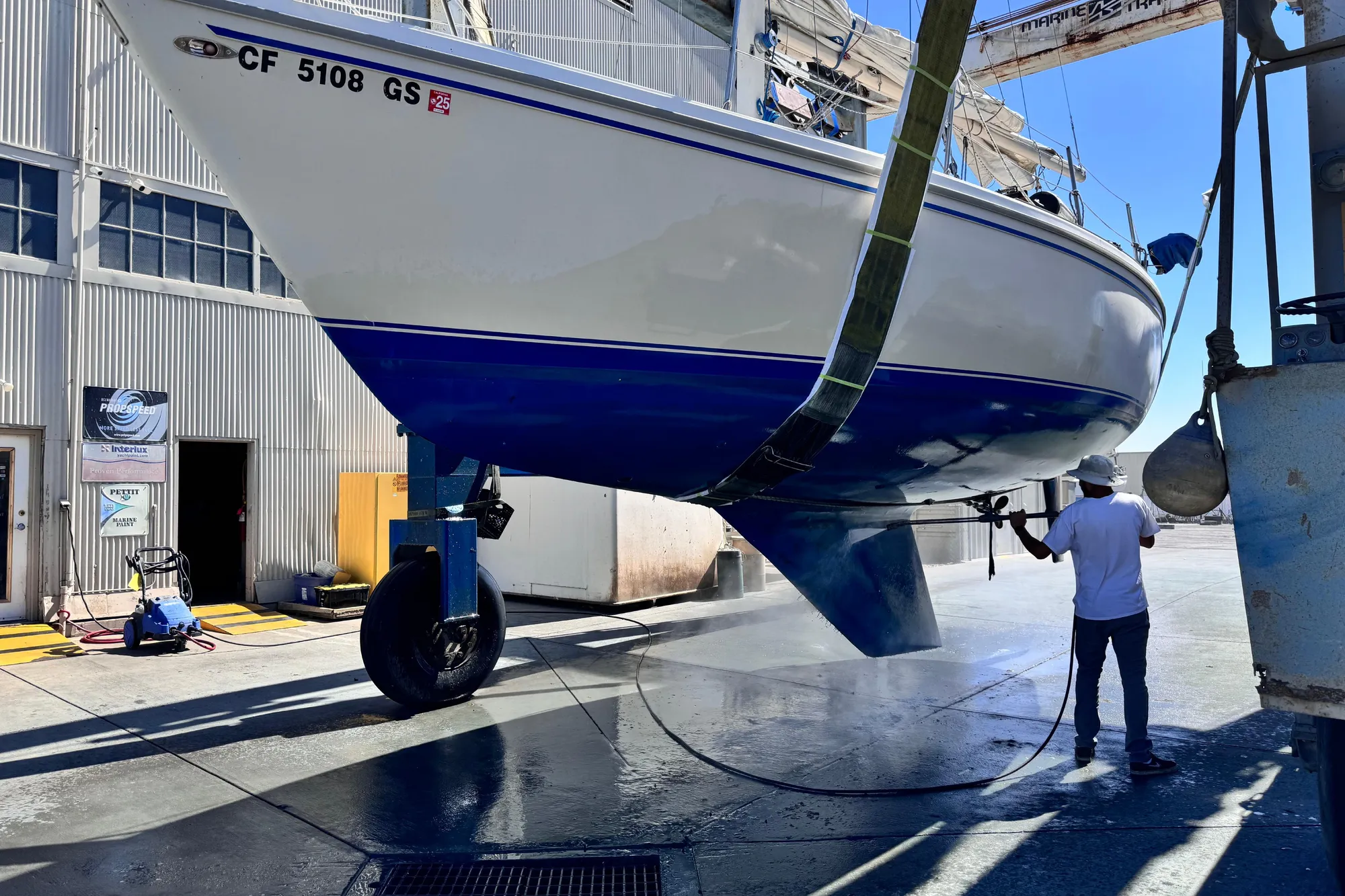 1980 Catalina 30 sailboat undergoing maintenance at a marina facility.