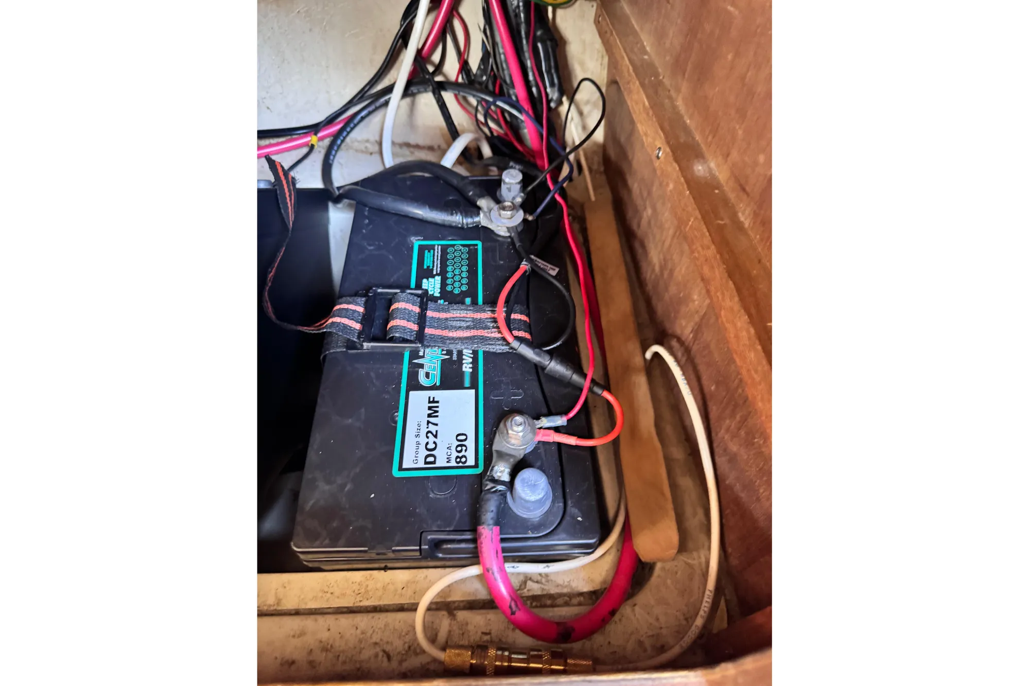 Battery compartment of a 1980 Catalina 30 sailboat with wiring connections.