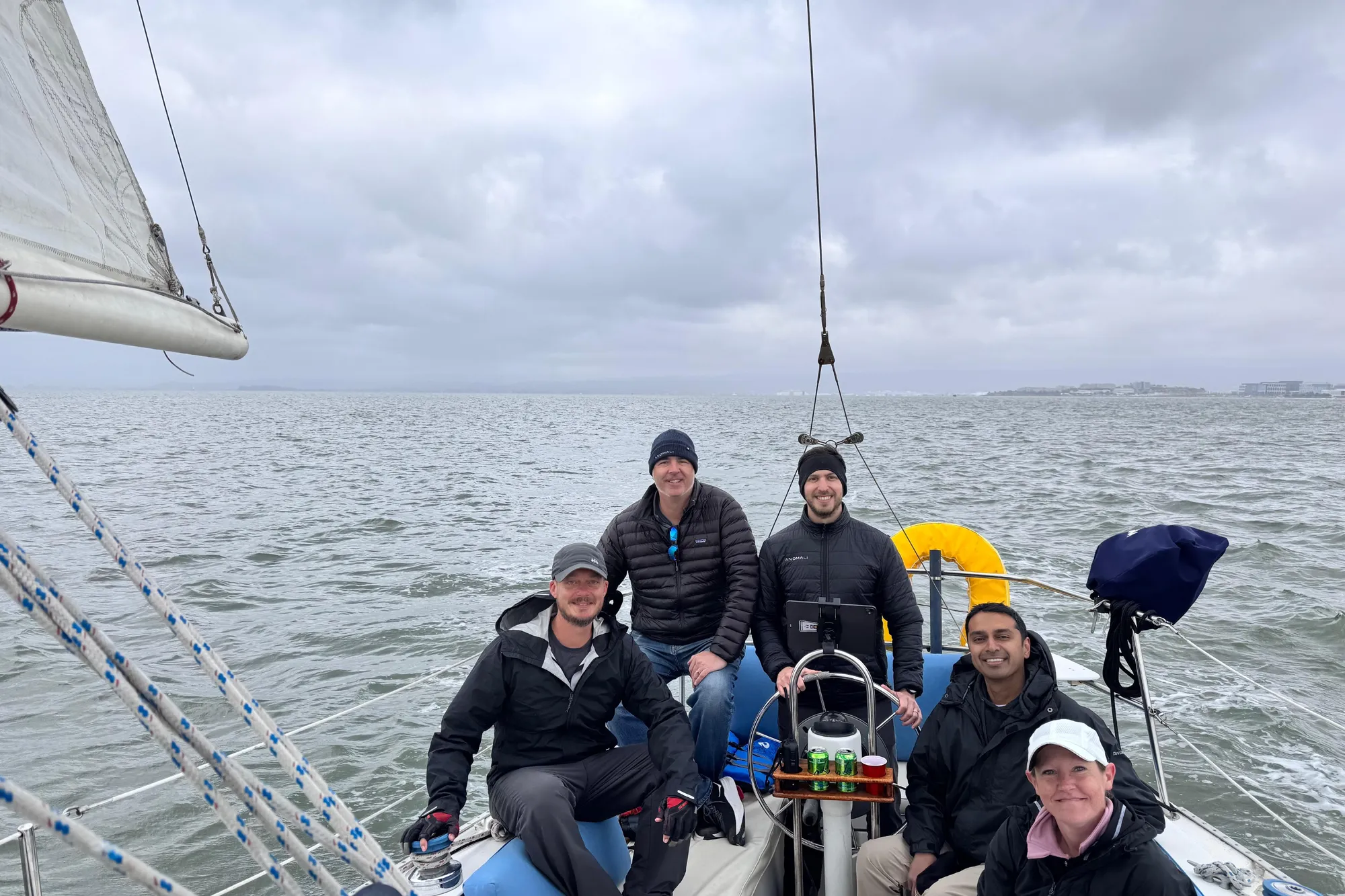 Group sailing on 1980 Catalina 30 boat under cloudy skies.