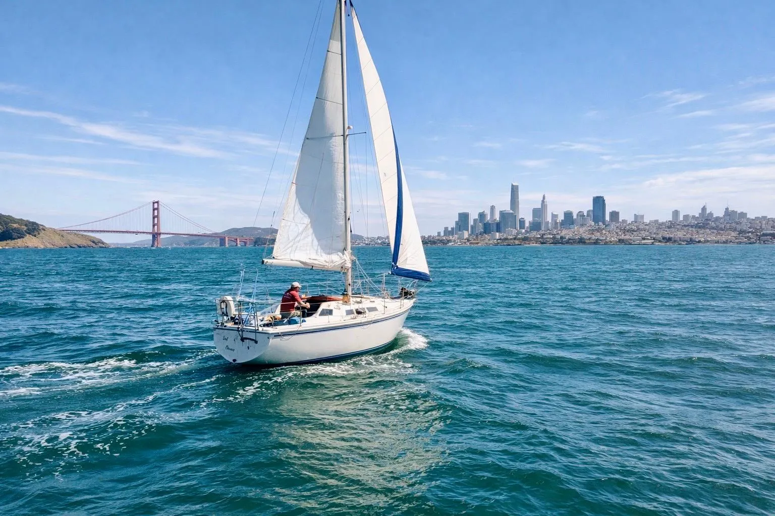 1980 Catalina 30 sailboat cruising near Golden Gate Bridge with San Francisco skyline.