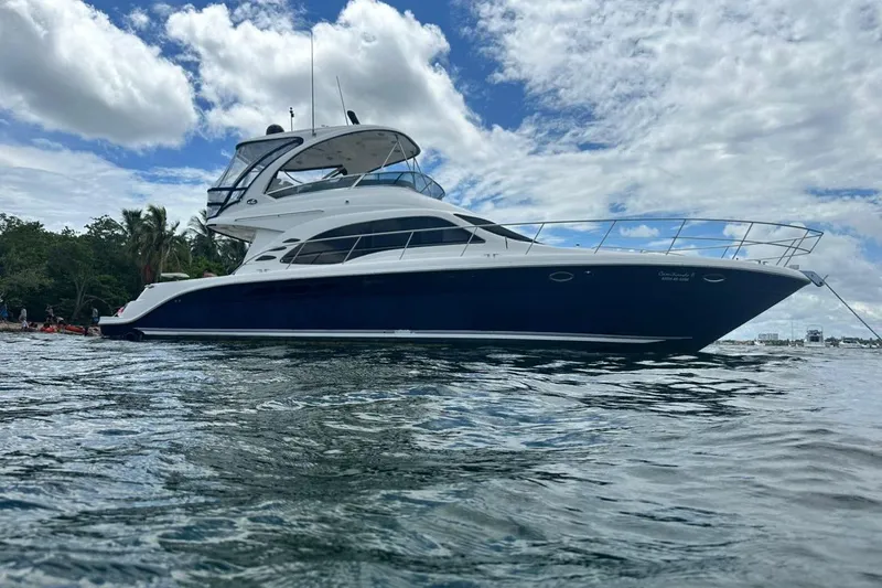  Yacht Photos Pics 2005 Sea Ray 500 Sedan Bridge yacht on water under cloudy sky.