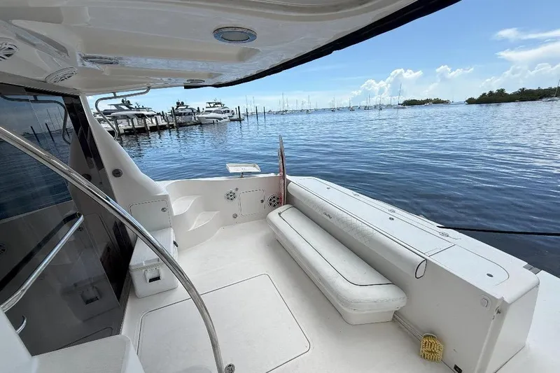  Yacht Photos Pics 2005 Sea Ray 500 Sedan Bridge yacht interior with marina view, featuring seating and sleek design.