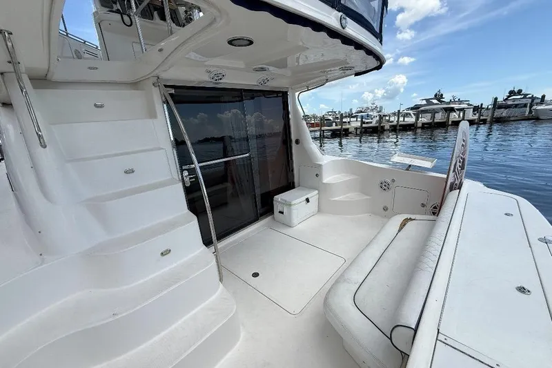  Yacht Photos Pics 2005 Sea Ray 500 Sedan Bridge yacht deck with seating, docked at marina.
