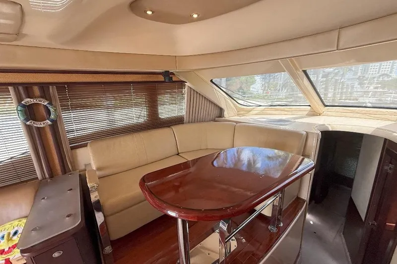  Yacht Photos Pics Luxurious interior of a 2005 Sea Ray 500 Sedan Bridge yacht with elegant seating and table.