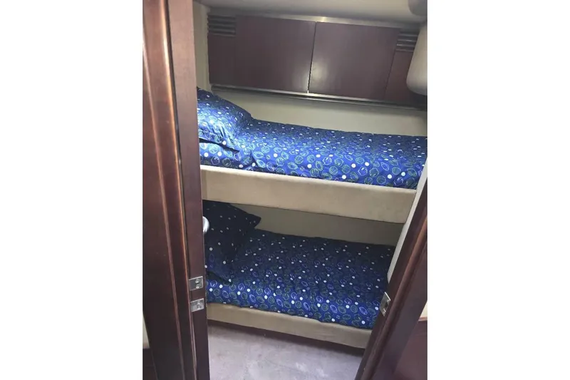  Yacht Photos Pics Bunk beds with blue bedding in 2005 Sea Ray 500 Sedan Bridge yacht cabin.