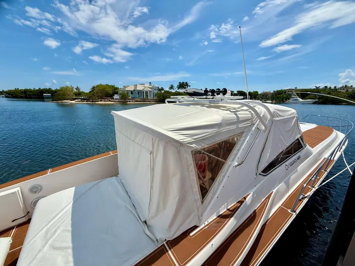  Yacht Photos Pics 2005 Fountain 48 Express Cruiser docked on a sunny day, with clear blue skies.