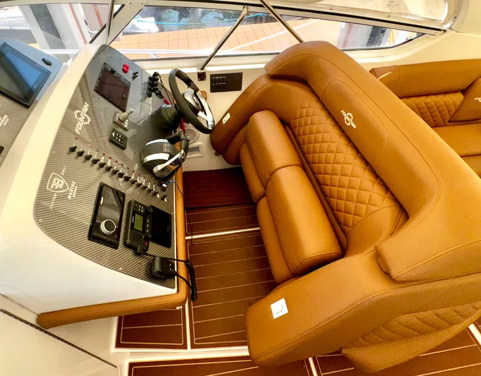  Yacht Photos Pics Luxurious interior of 2005 Fountain 48 Express Cruiser with brown leather seating and modern dashboard.