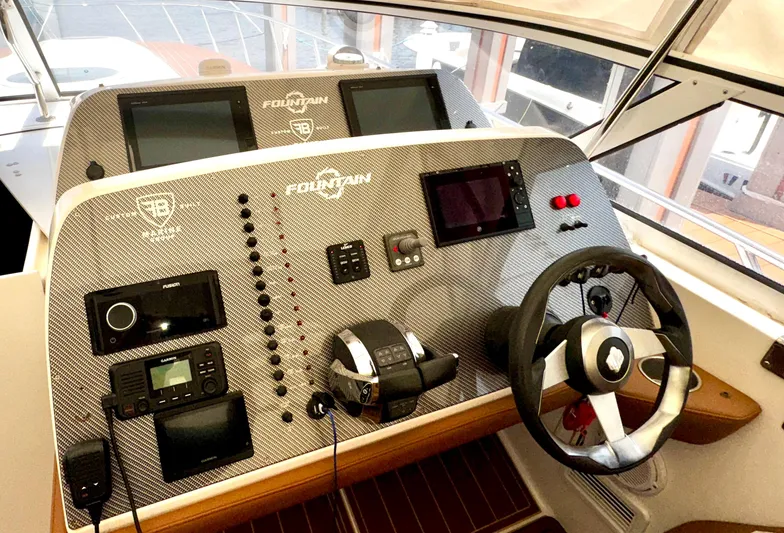  Yacht Photos Pics 2005 Fountain 48 Express Cruiser helm with advanced navigation and control systems.