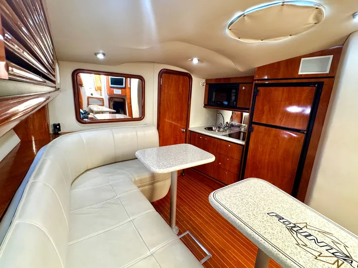 Yacht Photos Pics Luxurious interior of 2005 Fountain 48 Express Cruiser with leather seating and kitchenette.