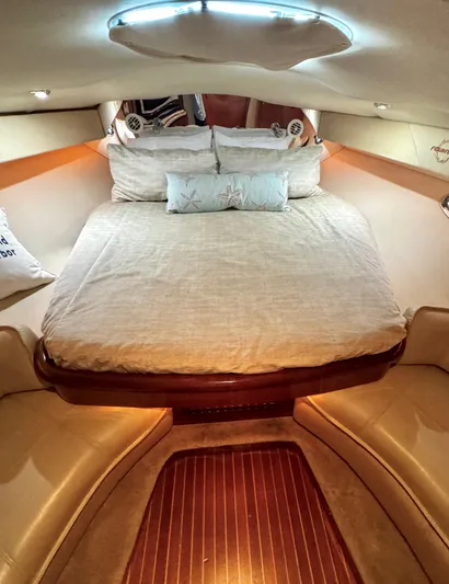 Yacht Photos Pics Luxurious cabin interior of 2005 Fountain 48 Express Cruiser with cozy bedding.